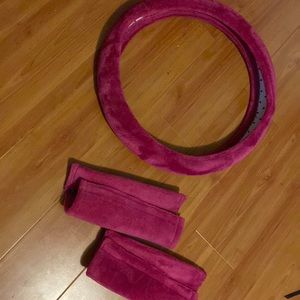 Pink fuzzy steering wheel cover and matching seatbelt covers